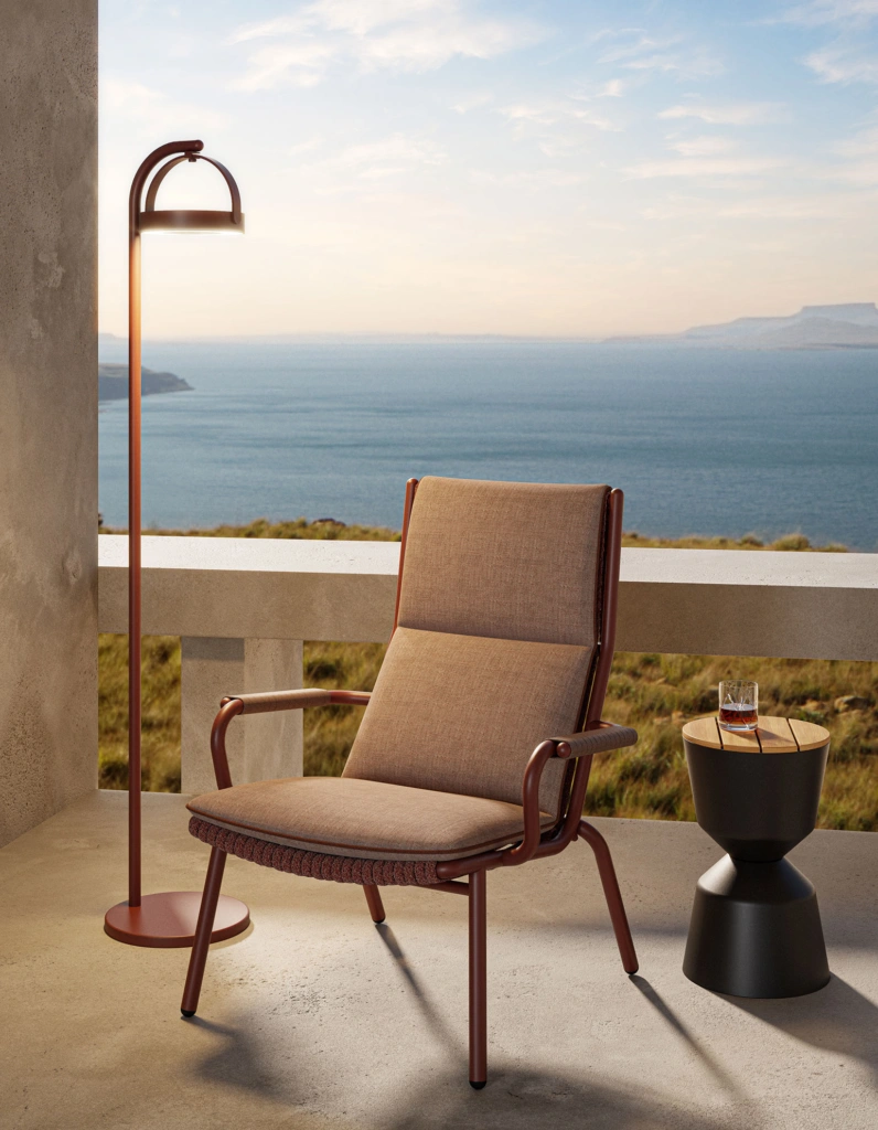 Loop Highback Lounge Armchair in a landscaped outdoor setting