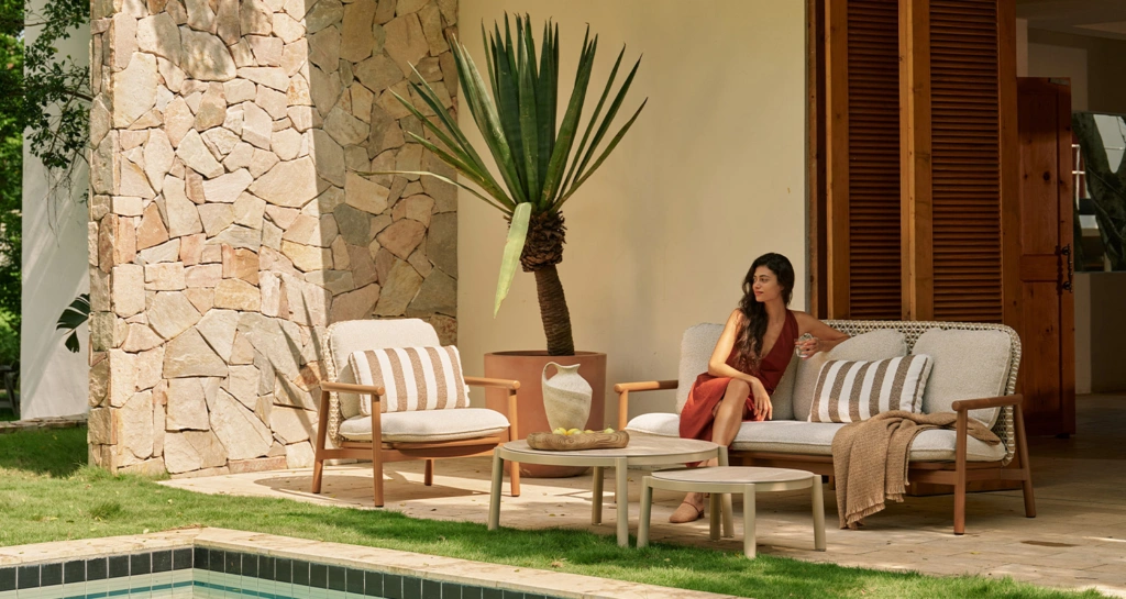Lille lounge armchair, 3-seat sofa and aluminum coffee tables beside a pool